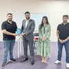 Ahmed Helal from The Socks Store receiving the Exporters – Youth Championship award, standing with event organizers and fellow participants during the ceremony in Bahrain.