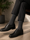 Charcoal gray seamless crew socks featuring a subtle embroidered AKYUT Minimal Logo on the side.