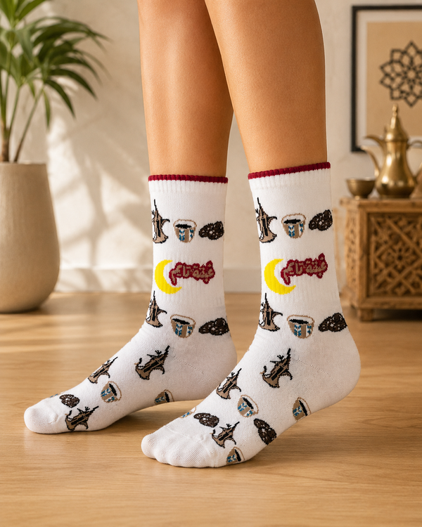 White crew socks featuring Arabic coffee dallah pots, traditional coffee cups, dates and yellow crescent design