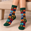Bahrain Heritage Patchwork Socks featuring colorful traditional Gulf geometric patterns, Arabic coffee pots, and heritage-inspired motifs with dark green cuffs and toes.