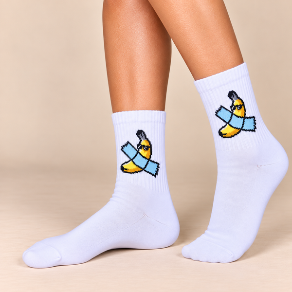 White crew socks with yellow banana wrapped in blue bandage design