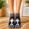 Grey ankle socks featuring a cute black and white tuxedo cat with yellow eyes and pink ears
