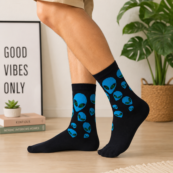 Black crew socks with blue alien head patterns and green eyes in a fun space-inspired design