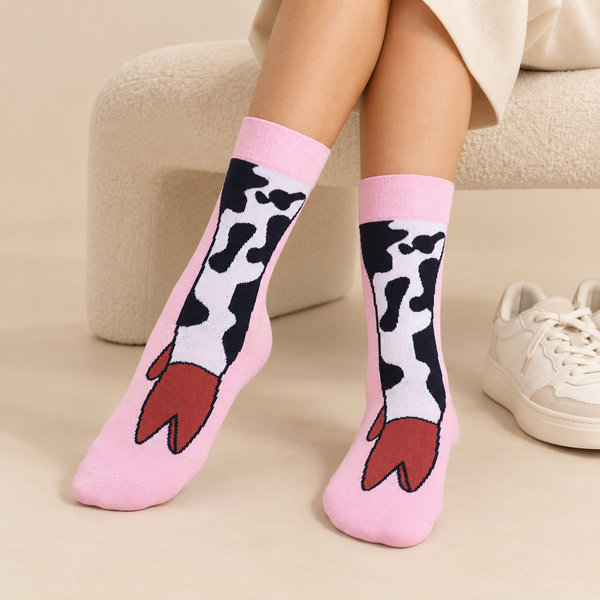 Pink crew socks featuring black and white cow legs with brown hooves