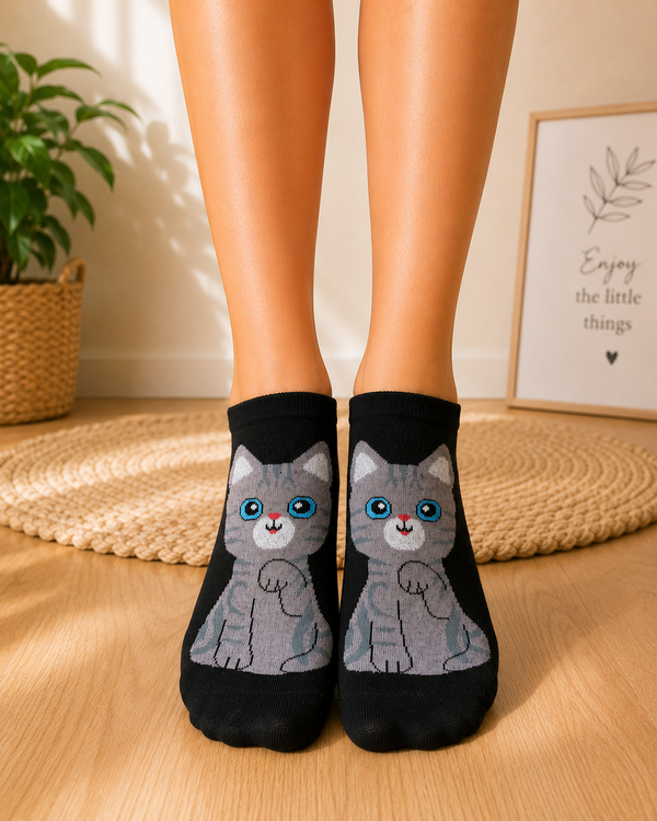 Black ankle socks featuring a cute grey cartoon cat with bright blue eyes and pink nose