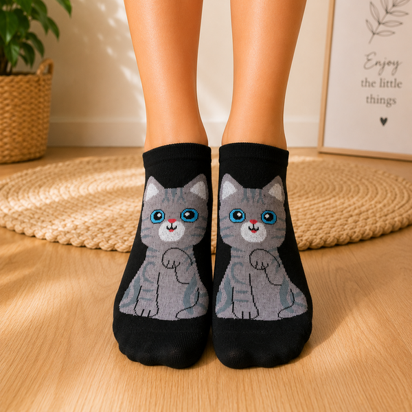 Black ankle socks featuring a cute grey cartoon cat with bright blue eyes and pink nose