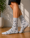 Light gray crew socks featuring an all-over pattern of cute panda faces with pink cheeks.