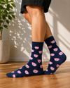 Navy blue crew socks featuring an all-over pattern of cute pink pig faces.