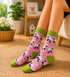 Pink socks with cute cartoon puppy patterns and green details