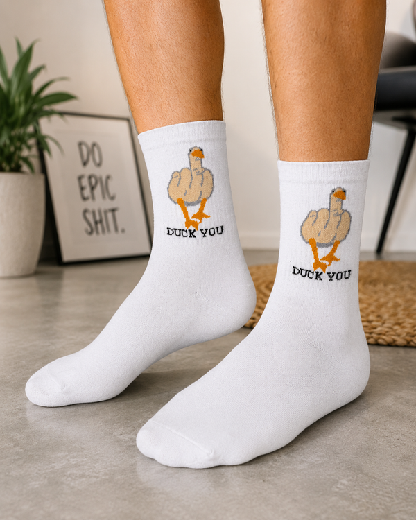 White crew socks featuring a funny duck-inspired graphic with humorous text for a playful novelty design.