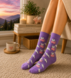 Purple crew socks with flying pink pig patterns and white clouds