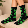 Black crew socks with all-over green leaf pattern