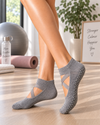 Grey crossover Pilates grip socks with anti-slip grip dots on the sole