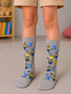 Grey kids crew socks featuring yellow Minions characters, colorful letters, and stars, designed for children aged 9–11 years.