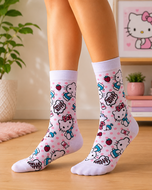 White Hello Kitty crew socks with pink polka dots, strawberries, bows and colorful character illustrations
