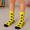 Yellow crew socks for kids aged 7–8 years featuring green snail patterns, green heels and black toes.