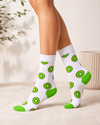 White crew socks with green kiwi fruit patterns and bright green heel and toe accents.