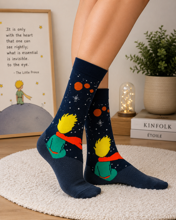 Dark galaxy-themed crew socks featuring a little prince inspired character sitting under stars