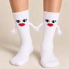 White crew socks with black eyes, red lips and soft magnetic hands that connect together