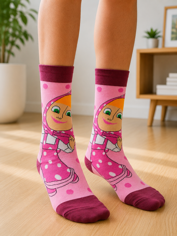 Pair of pink Masha Crew Socks featuring the cheerful cartoon character Masha in her signature pink outfit on a pink background.
