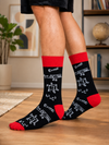 Black crew socks with red cuff, heel, and toe featuring mathematical formulas, equations, and geometry diagrams on a white background.