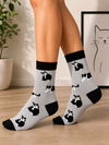 Minimal Cat Socks with black and white cat illustrations on a light gray crew sock design.