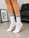 White crew socks featuring a bold Mother F*cker text design with black stripe detail.