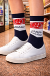 Navy and white crew socks with red striped O.K.logo and Arabic text design