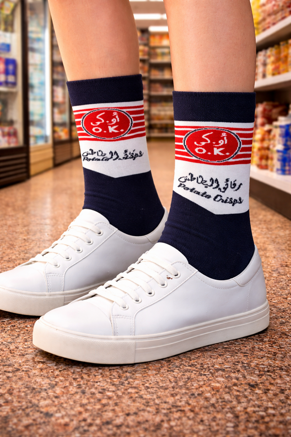 Navy and white crew socks with red striped O.K.logo and Arabic text design