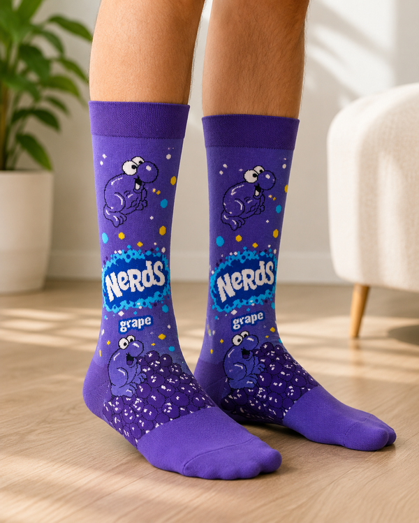 Pair of purple Nerds Grape Candy Crew Socks featuring classic Nerds characters and grape candy artwork on a white background.