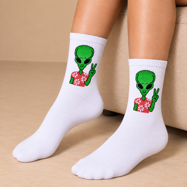 White crew socks with green alien wearing red floral shirt and giving peace sign