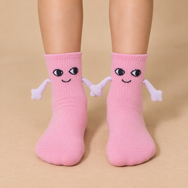 Pink kids socks with cute smiling faces and magnetic hands