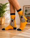 Yellow cartoon caveman crew socks with funny retro animated character design.