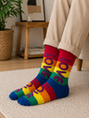 Colorful rainbow striped crew socks featuring large purple LOVE lettering