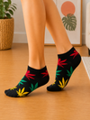 Black ankle socks with colorful red, yellow, and green leaf pattern design.