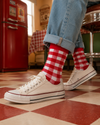 Red and white crew socks featuring a bold checkerboard plaid pattern with a classic retro-inspired style.