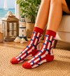 Red and white striped socks with blue dolphin patterns