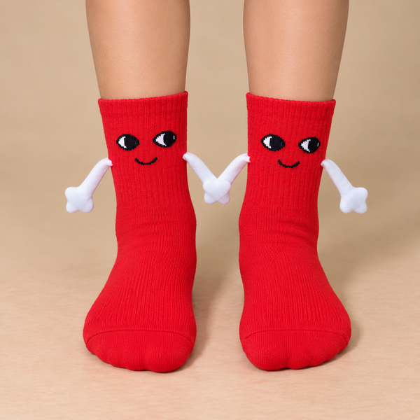 Red kids socks with cute smiling faces and magnetic connecting hands