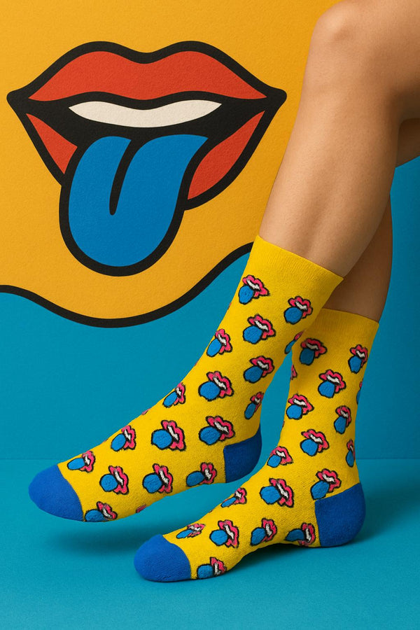 White crew socks featuring a repeating red tongue pattern with black cuffs and red heel and toe accents.