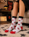 White crew socks featuring repeated red tongue graphic patterns with black and red details