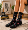 Black socks with colorful running people character pattern