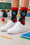 Dark socks with red cuff, heel, and toe featuring school classroom icons like globe, notebook, chalkboard, apple, and stationery