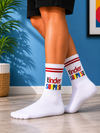 White crew socks featuring colorful Tinder Surprise text design with red striped cuff.