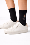 Main image: Black crew socks with wizard-school character wearing glasses and holding a wandModel image: Legs wearing black wizard-school character crew socks with white sneakersClose-up image: Close-up of wizard-school character design on black socks