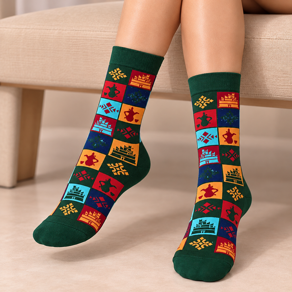 Bahrain Heritage Patchwork Socks featuring colorful traditional Gulf geometric patterns, Arabic coffee pots, and heritage-inspired motifs with dark green cuffs and toes.