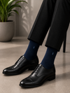 Navy blue bamboo dress socks featuring an embroidered Bambu Argyle Logo with a seamless crew-length design.
