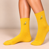 Mustard yellow crew socks with small embroidered peeled banana design