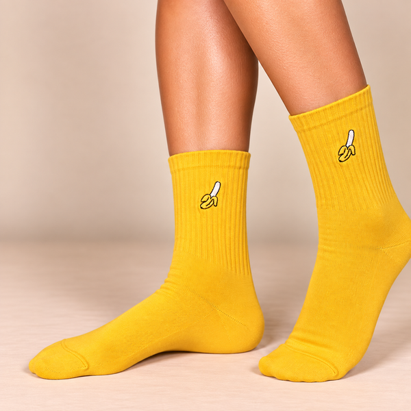 Mustard yellow crew socks with small embroidered peeled banana design