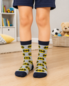 Grey Batman kids crew socks for children aged 5–6 years featuring an all-over Batman logo pattern with black cuffs, heel, and toe.