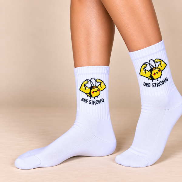 White crew socks with muscular yellow bee flexing and Bee Strong slogan